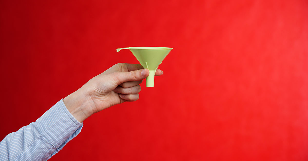 A man with his arm and hand extended. The man is holding a funnel over a red background.