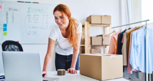 Small business owner on laptop learning why she needs a website.