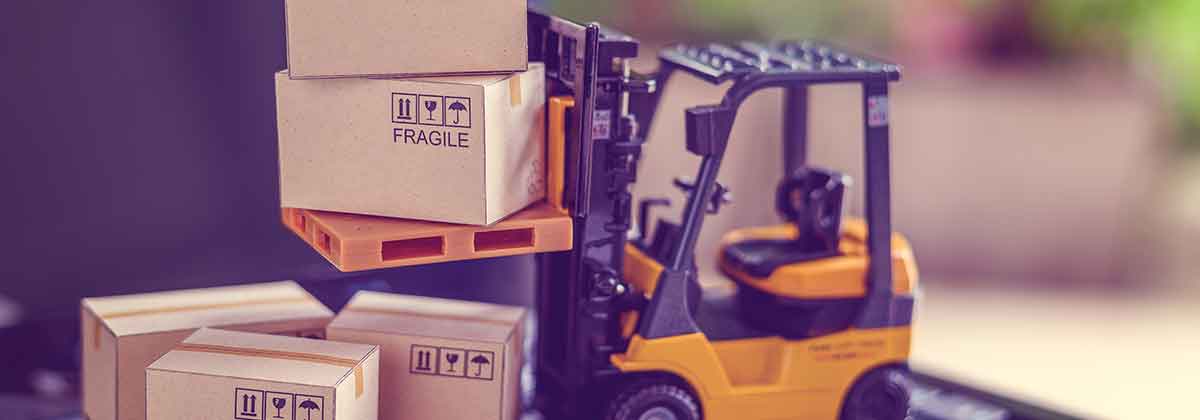 Forklift with boxes sitting on laptop