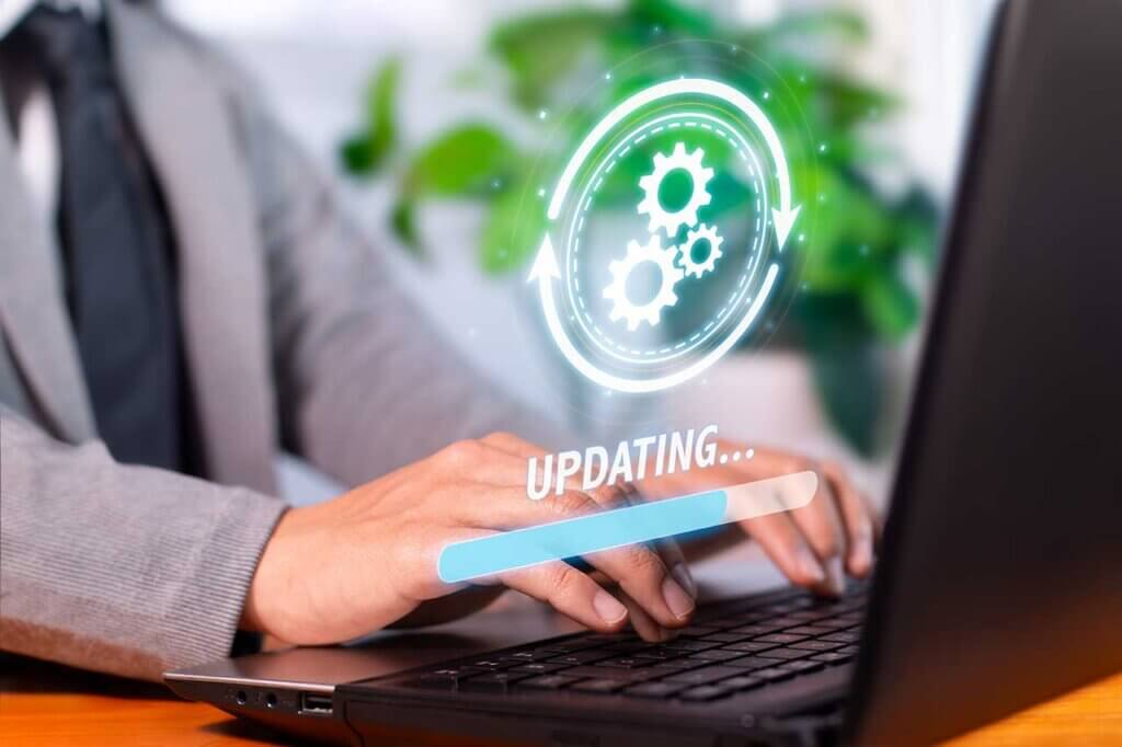 Developer sitting at laptop updating website.
