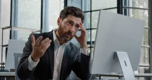 Business man frustrated at AI hallucinations.