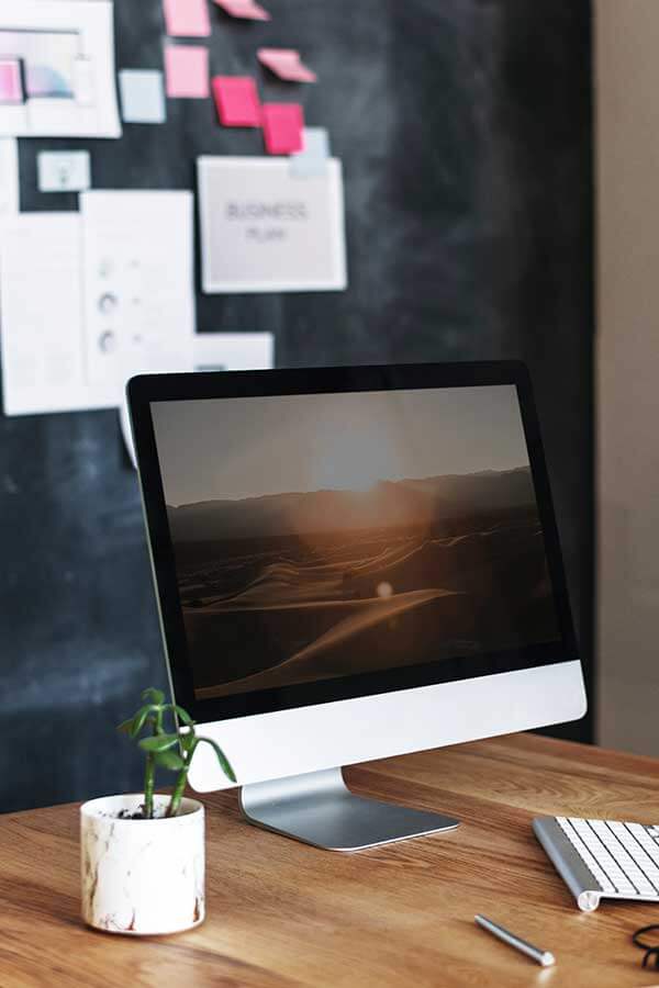 Computer on a desk in an office.