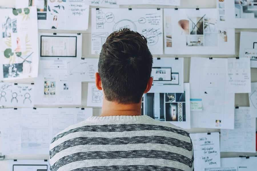 Man looking at strategic options on display board.