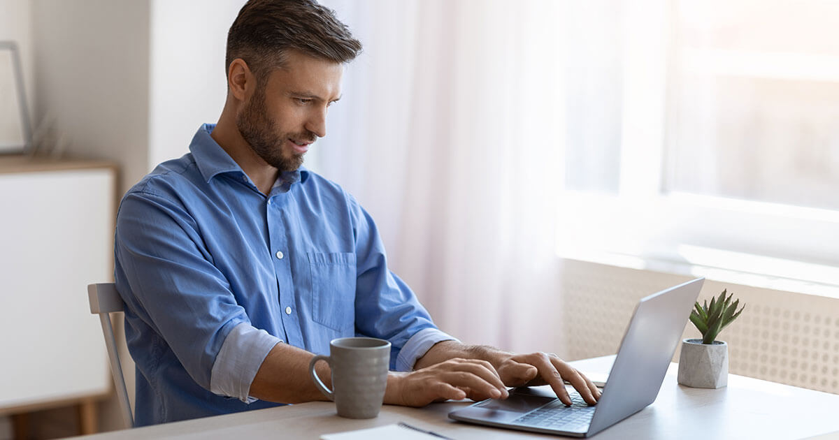 Man searching the internet on laptop.