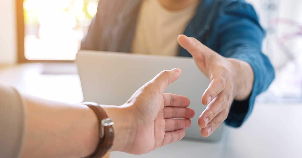 Two businessman open hand to shaking hands.