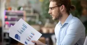 Small business owner reviewing AI analytics.