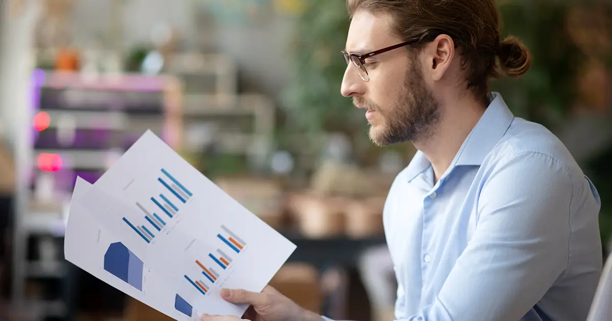 Small business owner reviewing AI analytics.