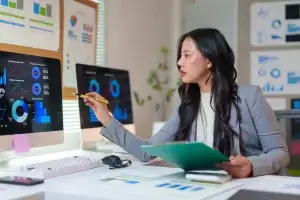 Businesswoman pointing at computer screen