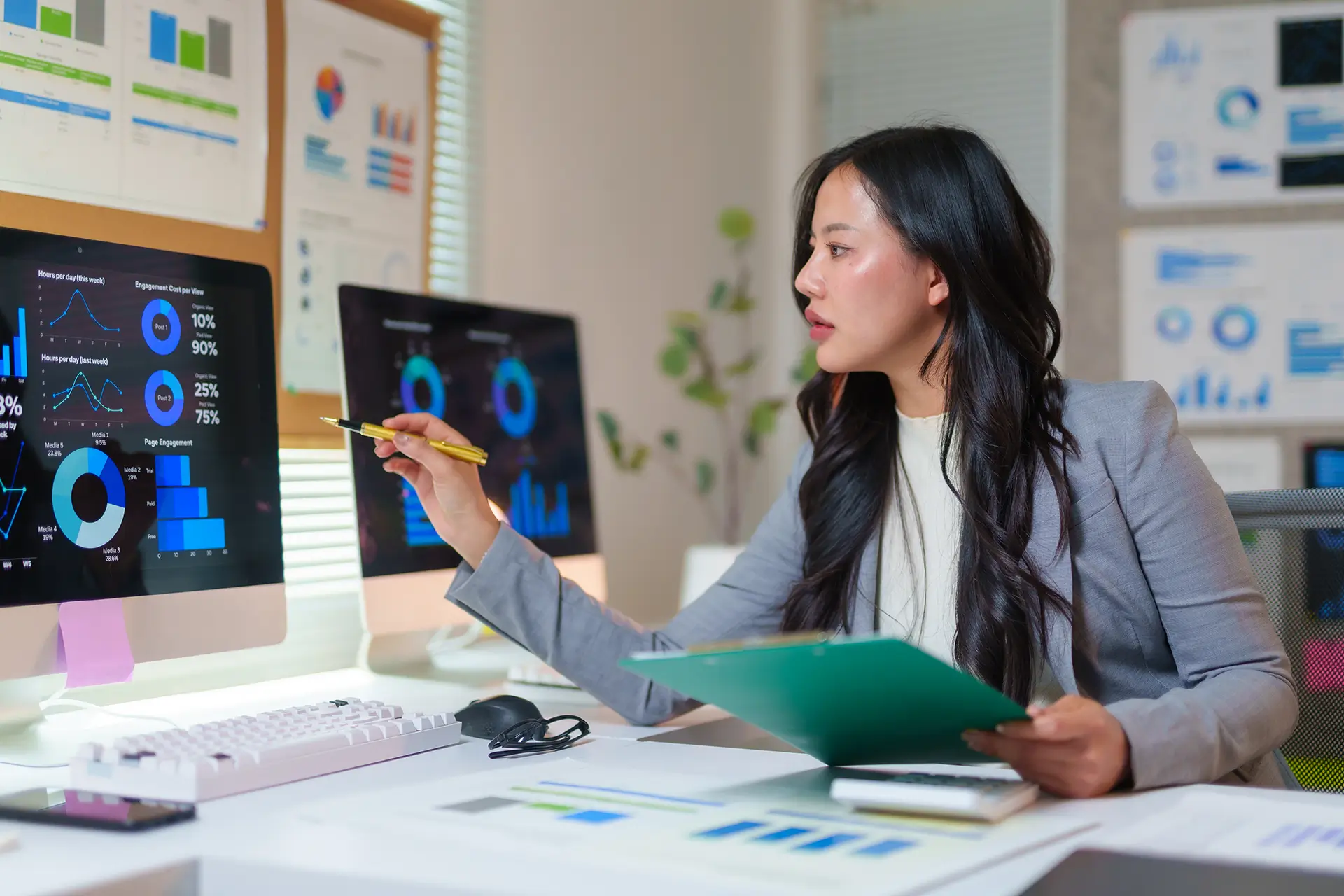 Businesswoman pointing at computer screen