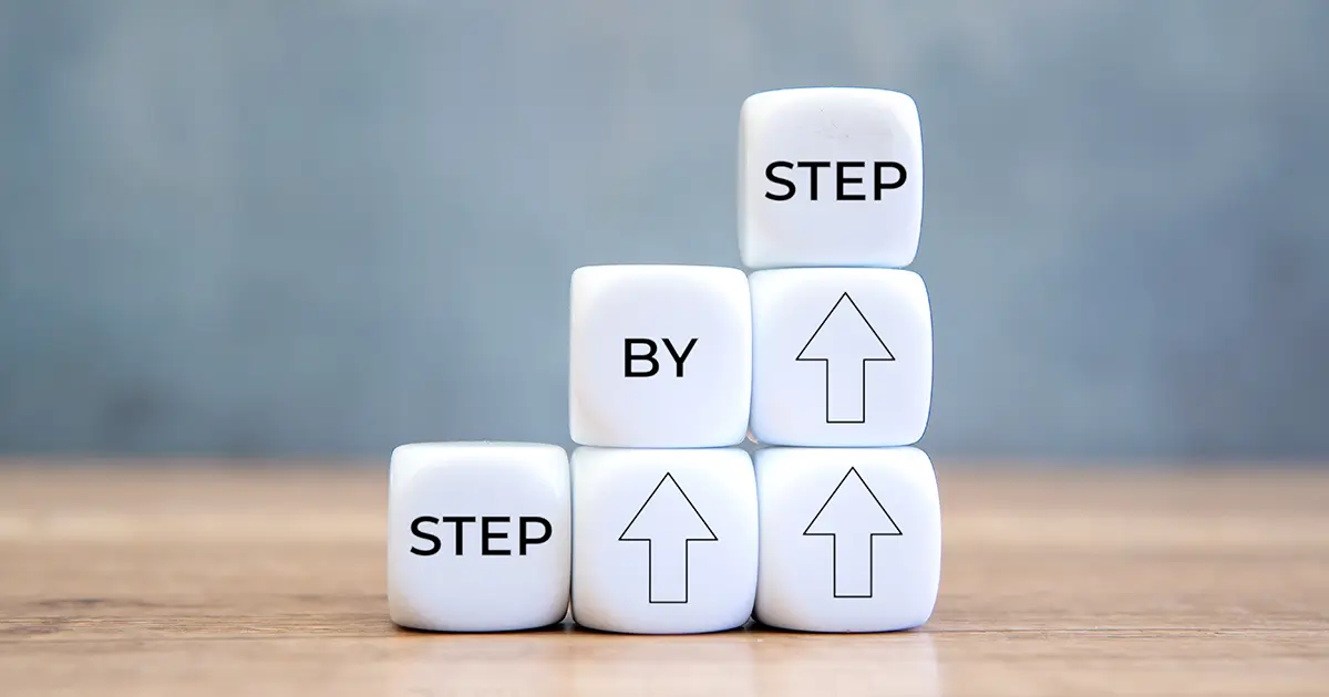 White blocks with the words step by step.